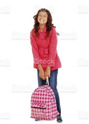school girl child trying to lift heavy backpack on white background
